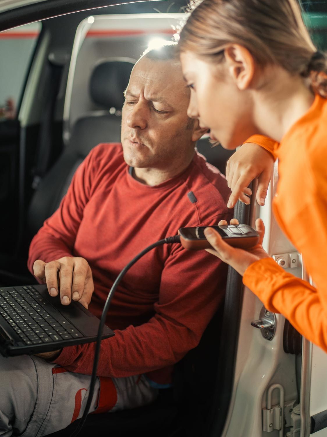 farther and daughter working on car