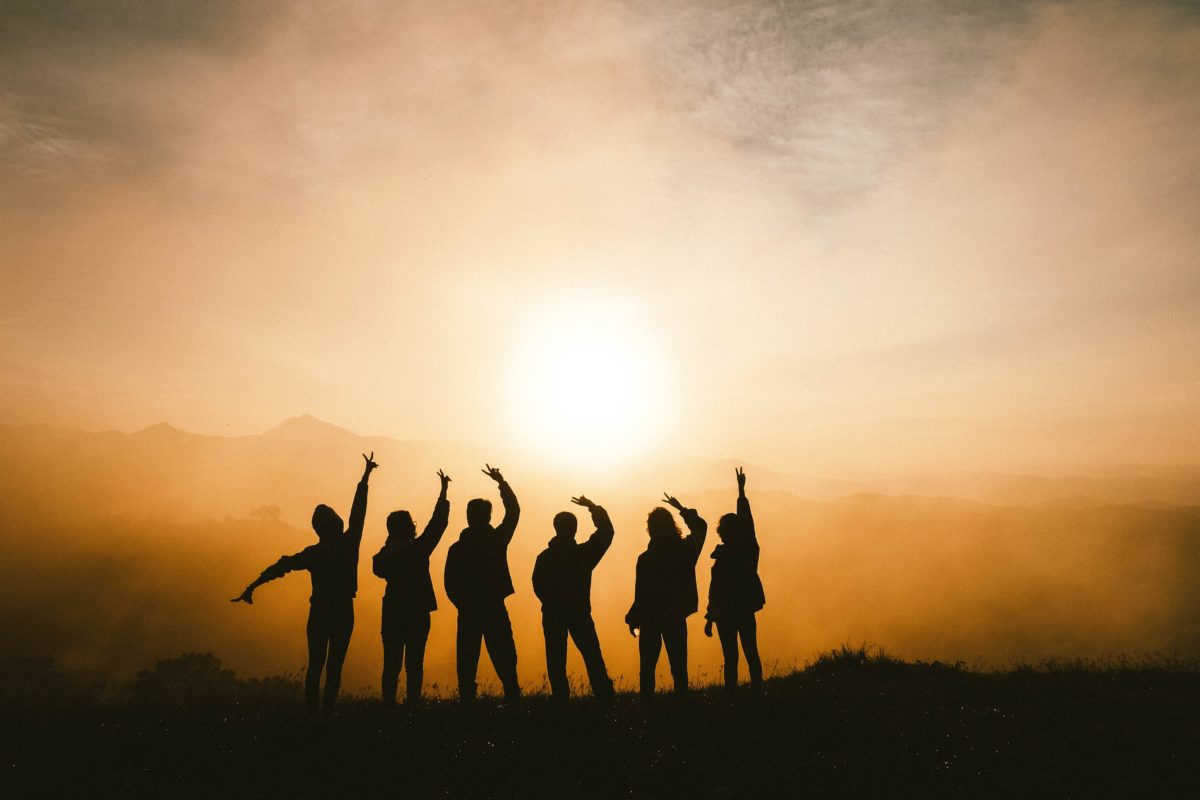 People standing in the sunset